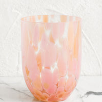 Peach / Maxi: A handmade speckled glass juice cup with peach and pink spots.