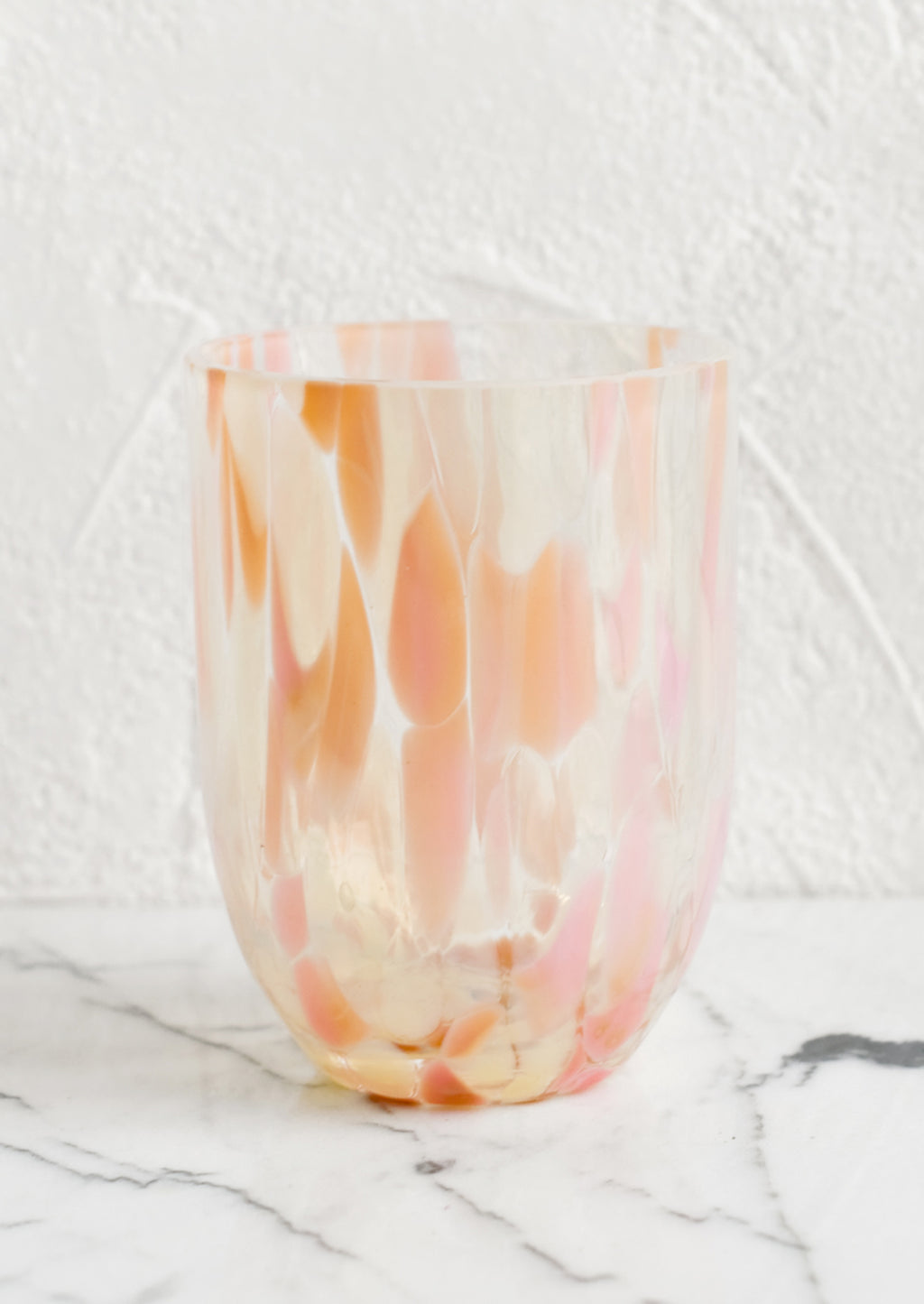 Peach / Sparse: A handmade speckled glass juice cup with peach and pink spots.