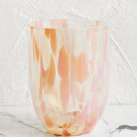 Peach / Sparse: A handmade speckled glass juice cup with peach and pink spots.