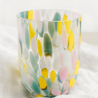 Multi / Maxi: A handmade speckled glass juice cup with teal, yellow and pink spots.