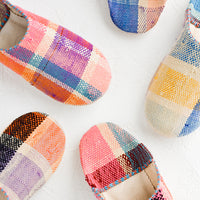 Small / Madras: An assortment of house slippers made from colorful plaid fabric.