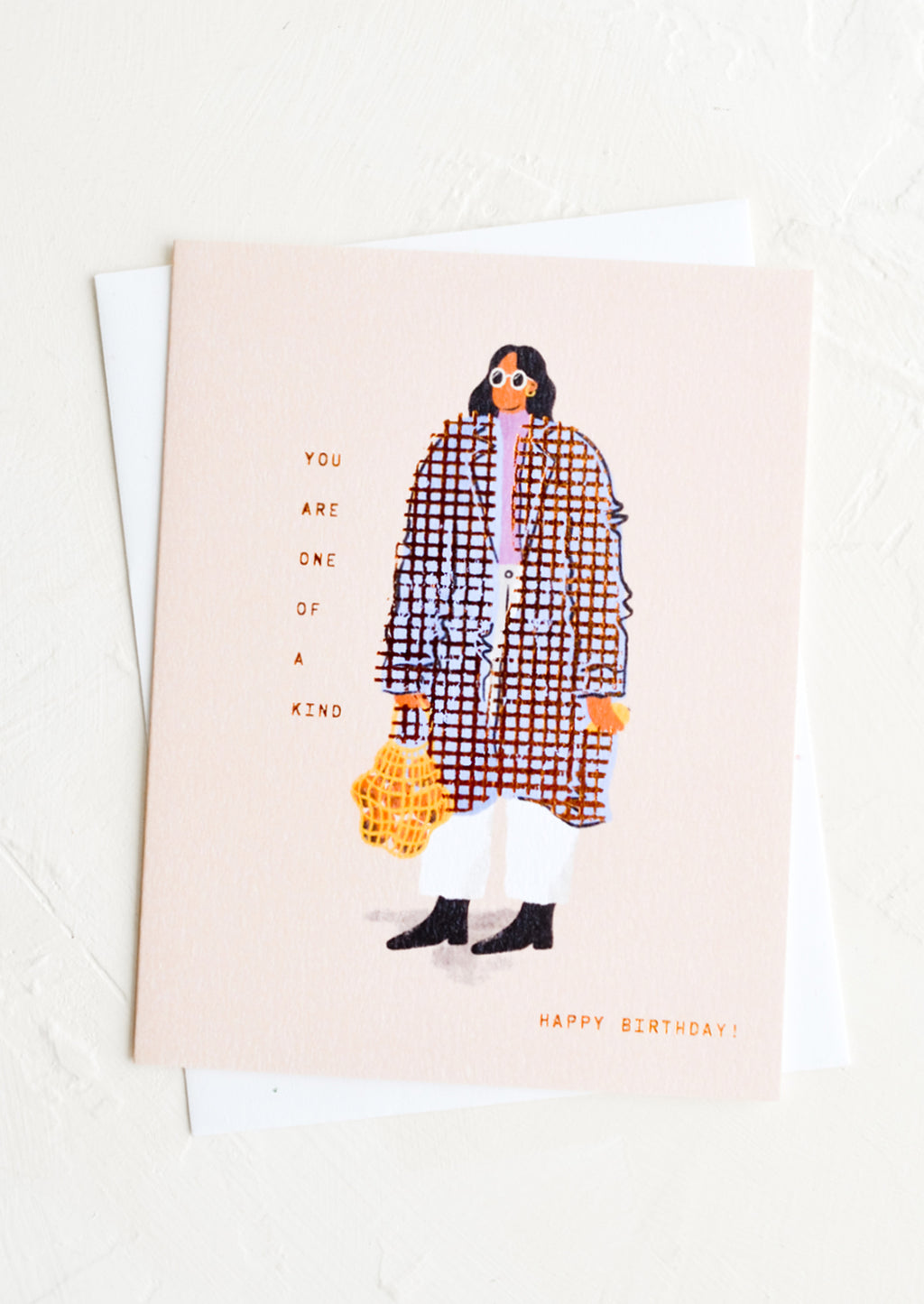 2: A greeting card with image of woman wearing baggy coat, text reads "You are one of a kind, happy birthday".