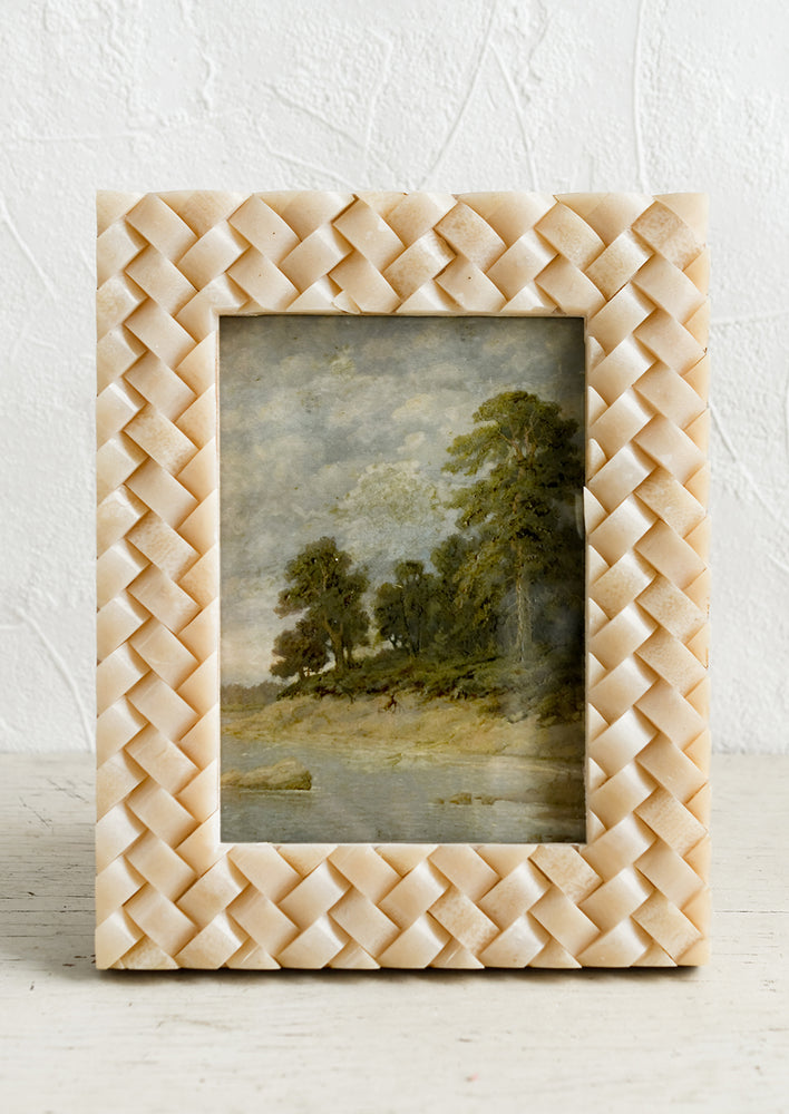 A resin picture frame in tan with basketweave texture.
