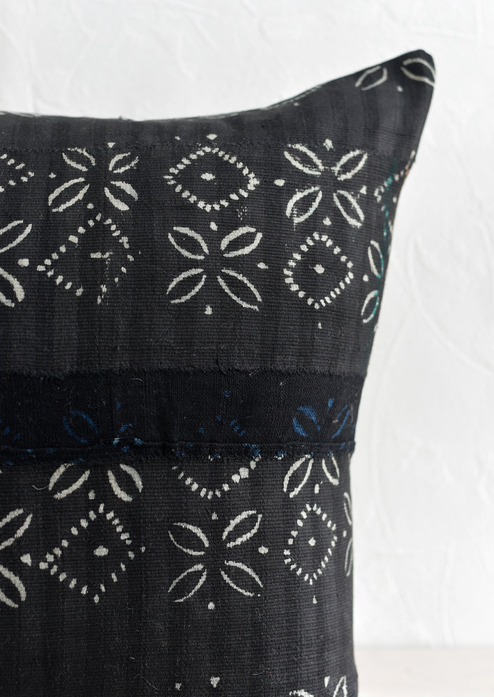 Batik strip cloth fabric in dark color with light print.