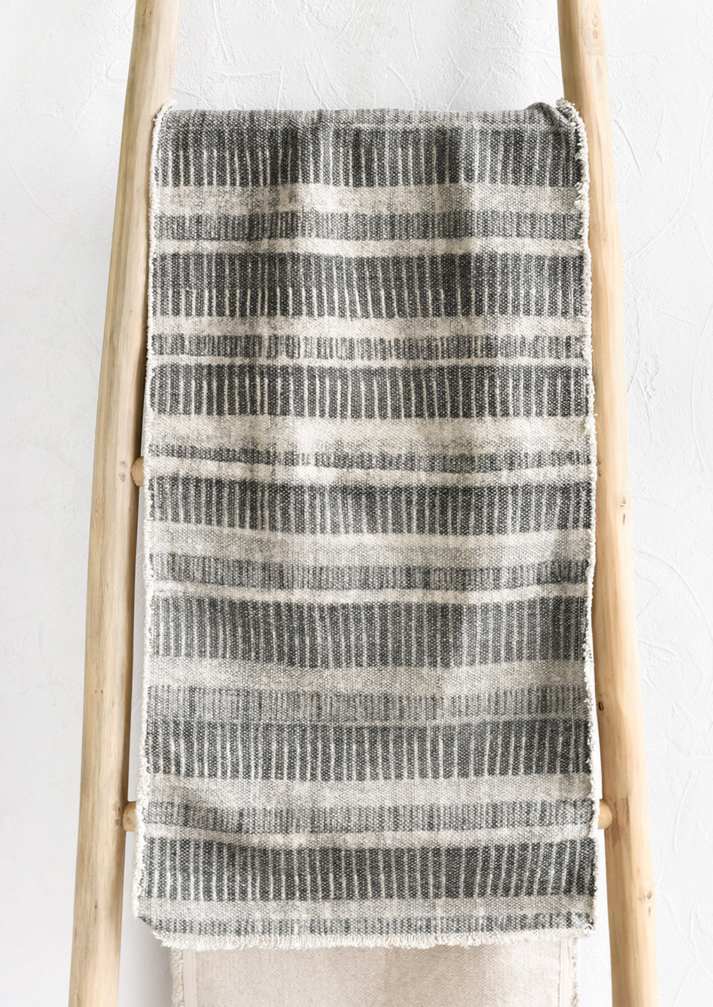 1: A table runner in grey stripe print.