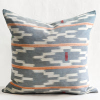 1: A throw pillow made from indigo baule fabric with peach stripes.
