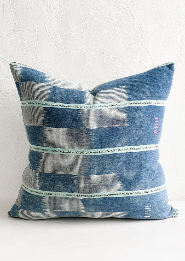 A pillow made from indigo ikat fabric.