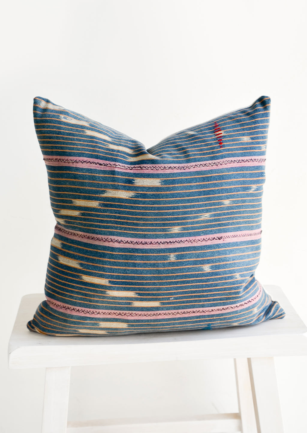 3: Throw pillow made from vintage indigo Baule fabric with peach and pink stripes
