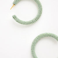 Mint: Thick hoop earrings of mint green colored glass beads.