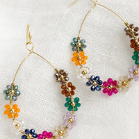 Brights Multi: A pair of gold teardrop wire earrings with bright floral beading.