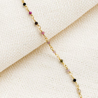 1: A gold wire bracelet with small multicolor tourmaline beads.
