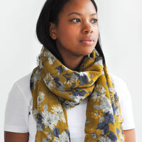 4: Product shot of woman wearing scarf and white top.