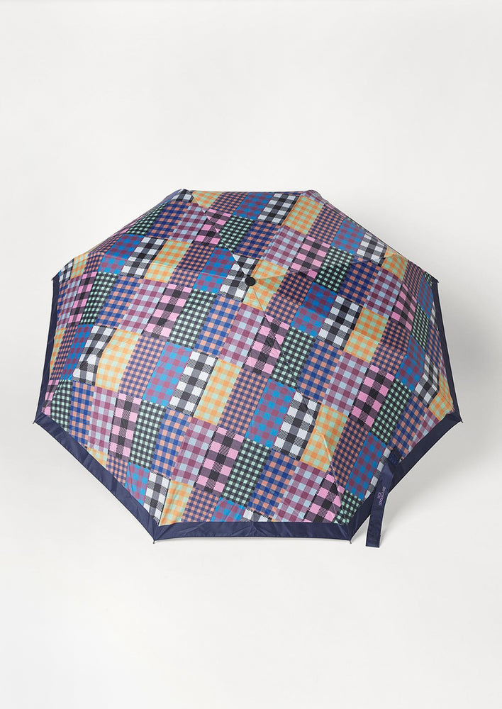 2: A nylon umbrella in checkered patchwork print.
