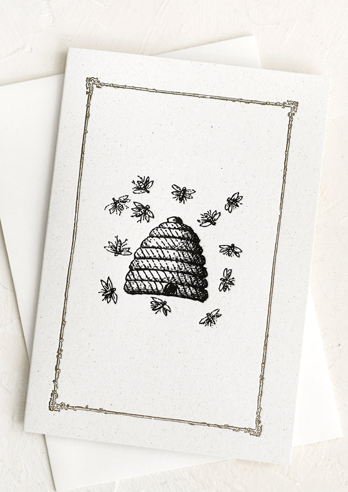 A plain card with border and beehive graphic at center.