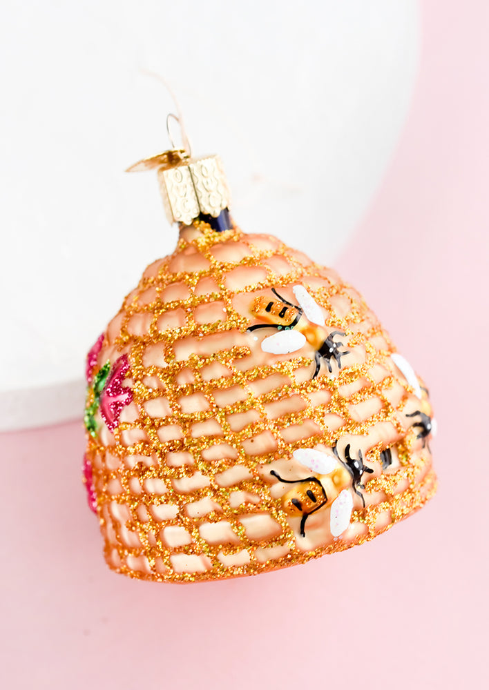 A glass ornament in shape of beehive.