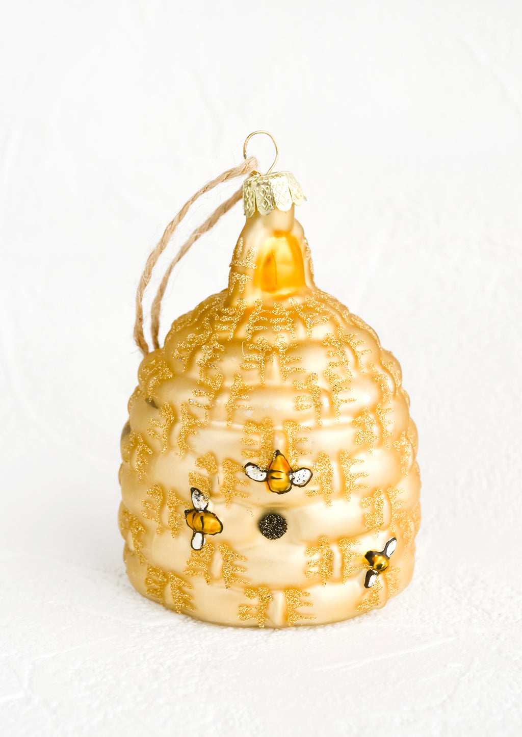 2: A glass ornament in the shape of a beehive with painted on bees.