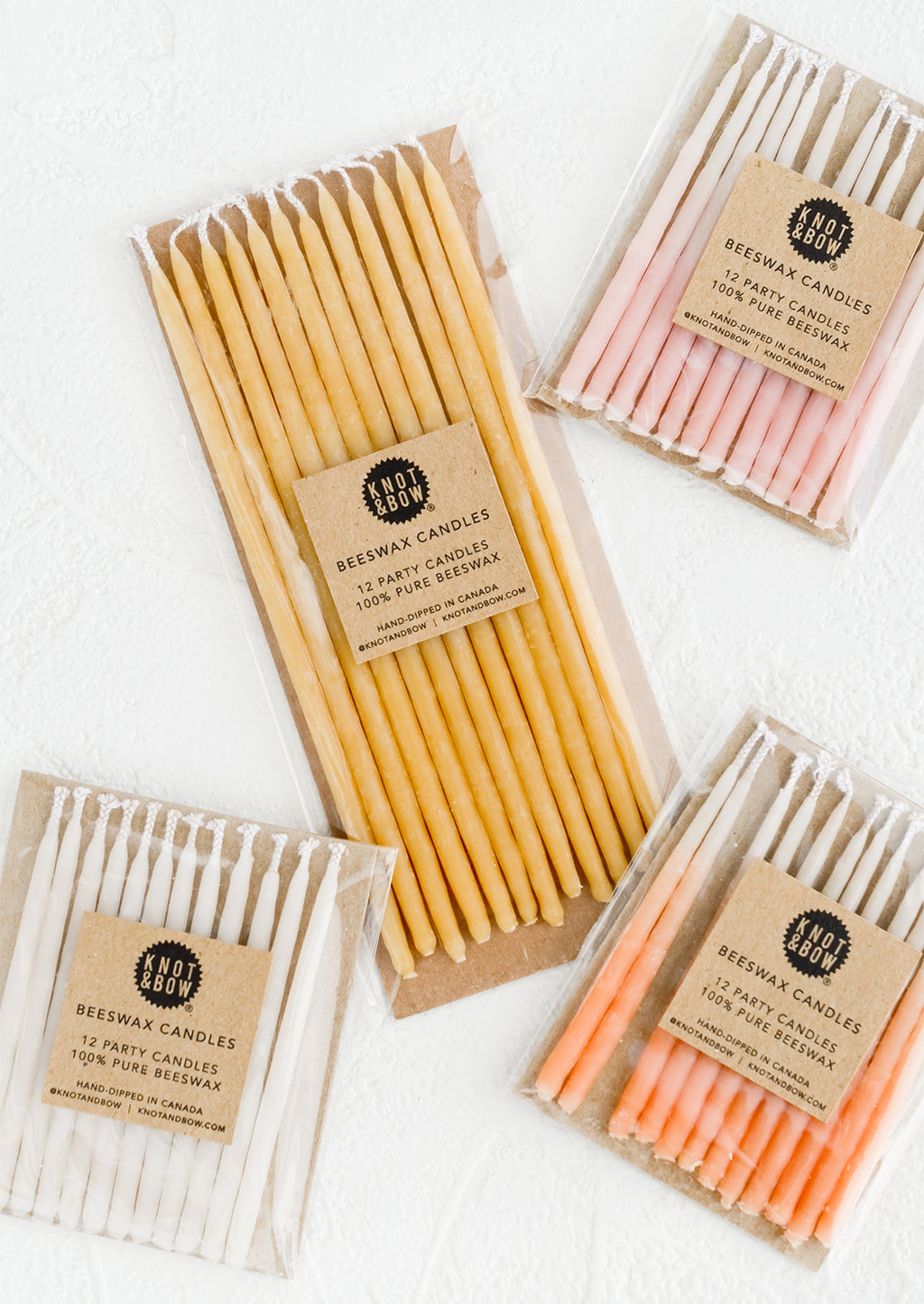 Short / Pink Ombre: Packages of beeswax birthday candles in a mix of colors and sizes.
