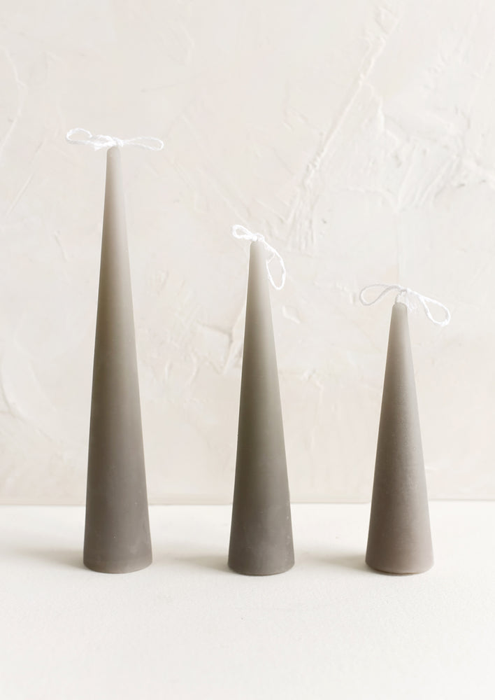 Small / Concrete: Three cone-shaped taper candles in light grey.