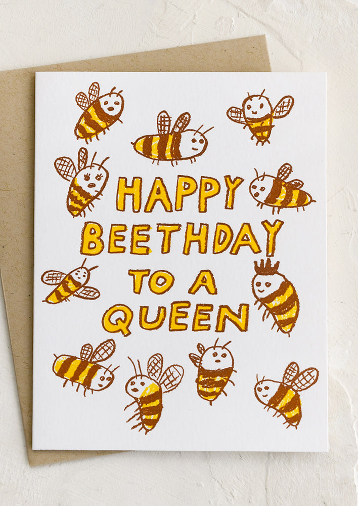 A bee print card reading "Happy Beethday to a queen".