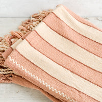7: Natural woven cotton throw in blush and cream stripes with twisted fringe edge