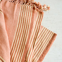 Blush / Terracotta: Natural woven cotton throw in beige and terracotta stripes with twisted fringe edge