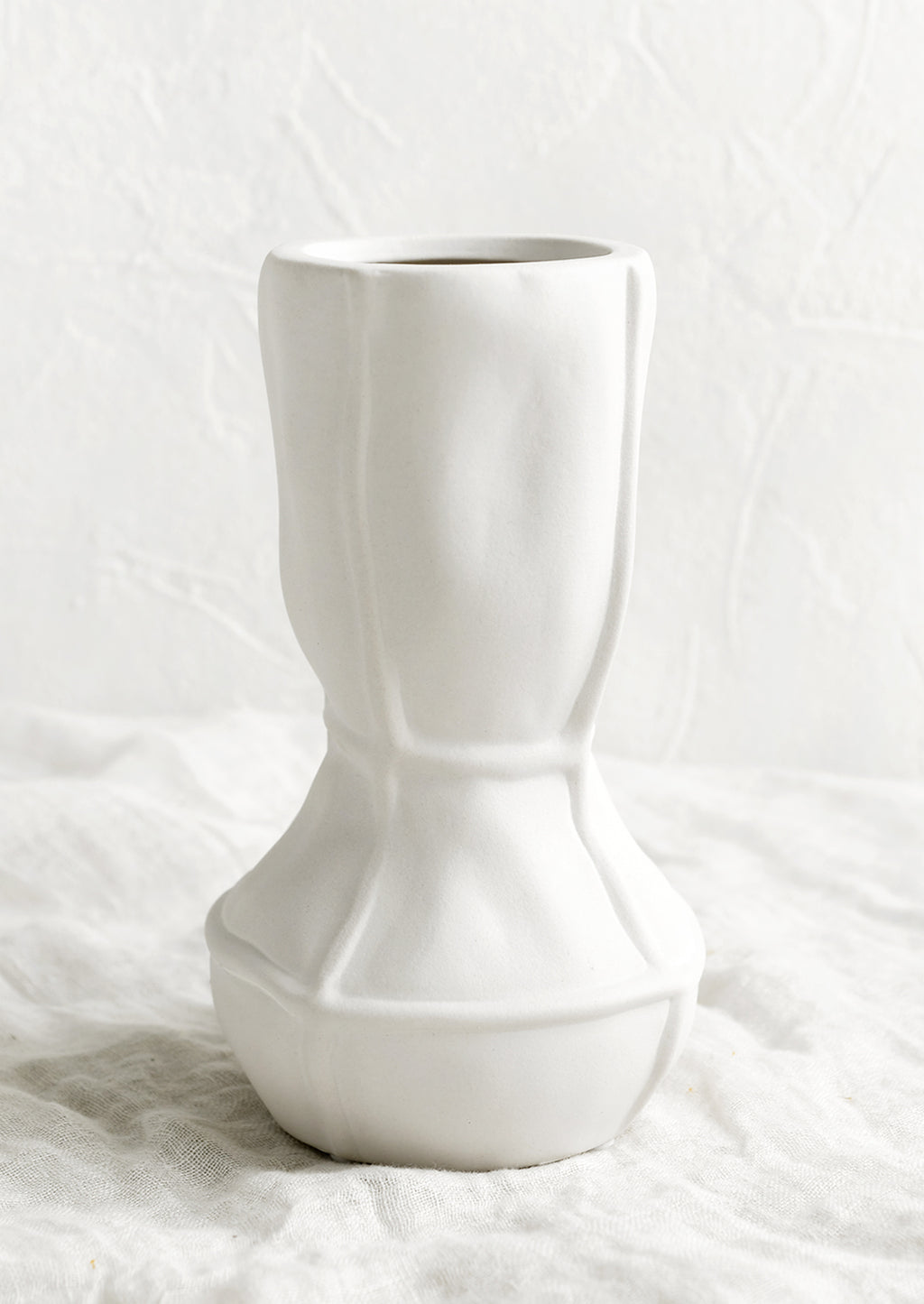 Tall: A tall geometric vase in matte white ceramic.