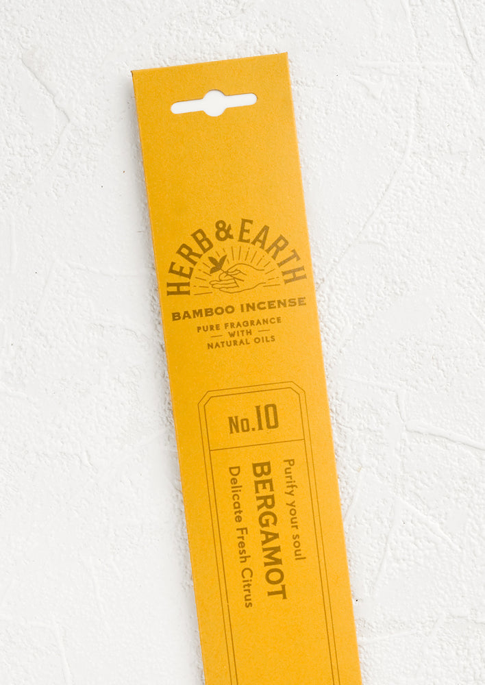A yellow packaging sleeve containing bergamot scented incense.