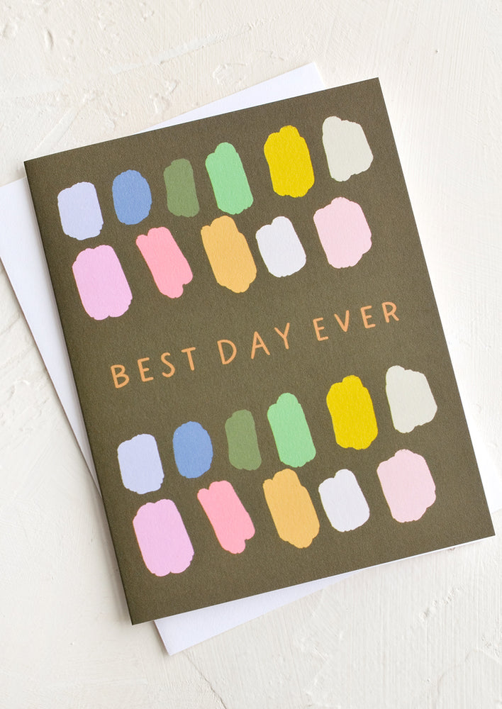 A greeting card with colorful paint swatches and text at center reading "Best day ever".