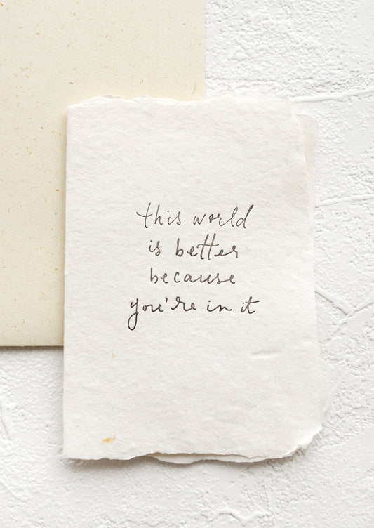A greeting card with text reading "this world is better because you're in it".