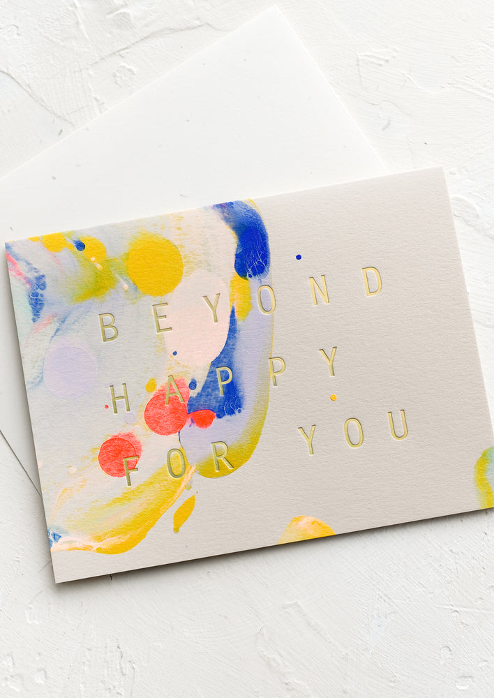 A painted card reading "Beyond happy for you".