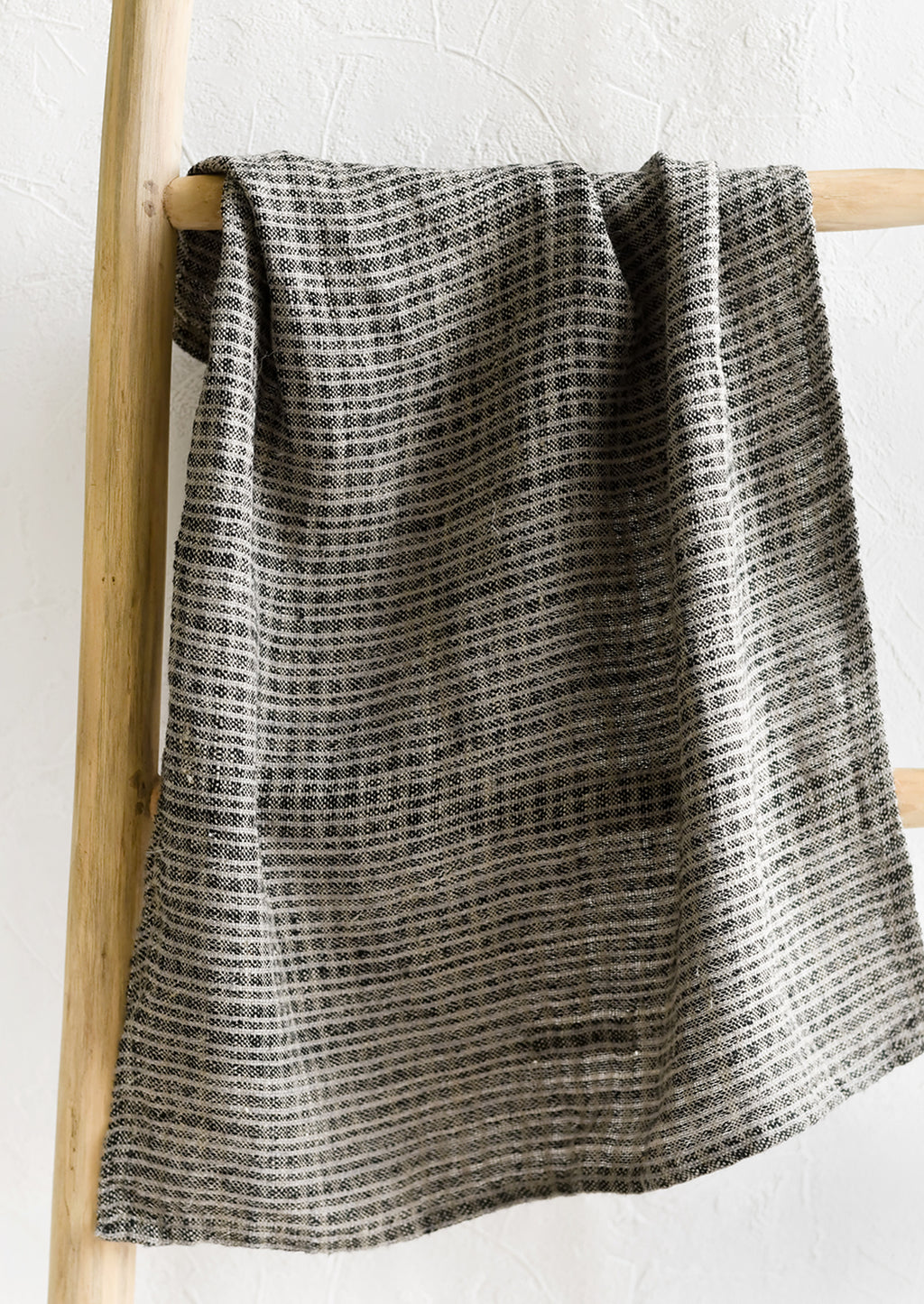 1: A linen tea towel in black and grey mini check print.