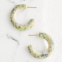 Valley Tie Dye: A pair of painted wood hoop earrings in speckled pattern.