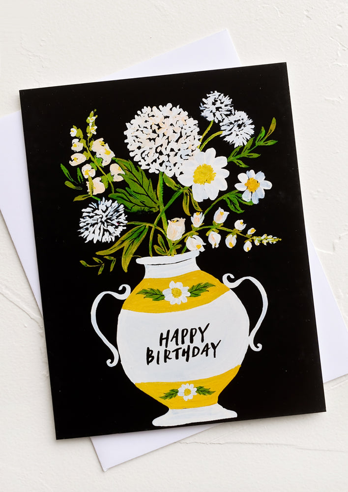 A greeting card with flowers in a vase, text on vase reads "Happy birthday".