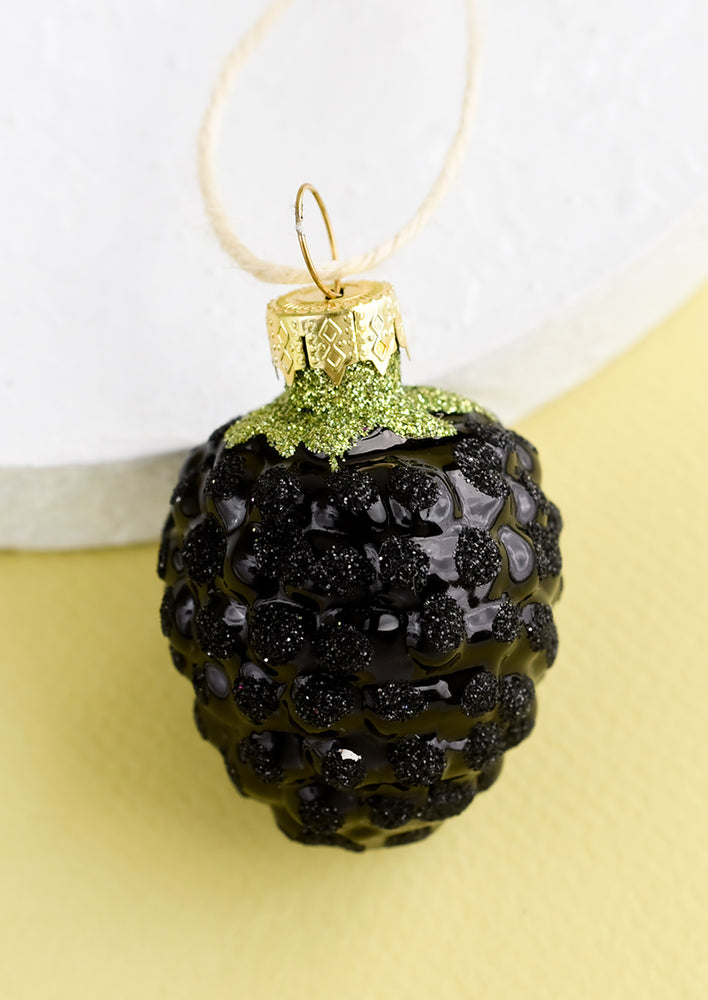 1: A decorative holiday ornament in the shape of a blackberry.