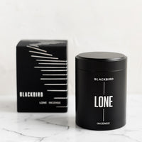 Lone: A black incense tin with black and silver packaging.