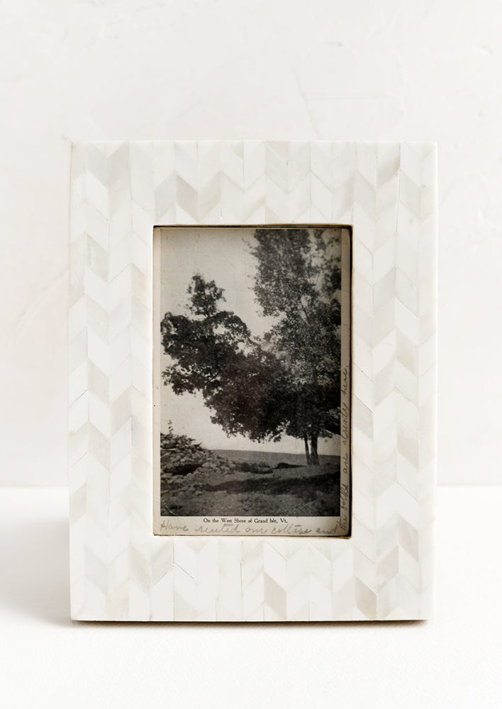 A picture frame in chevron pattern made from ivory bone.