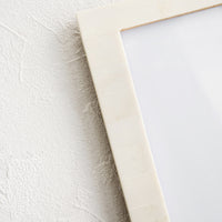 2: Picture frame with pale ivory resin border.