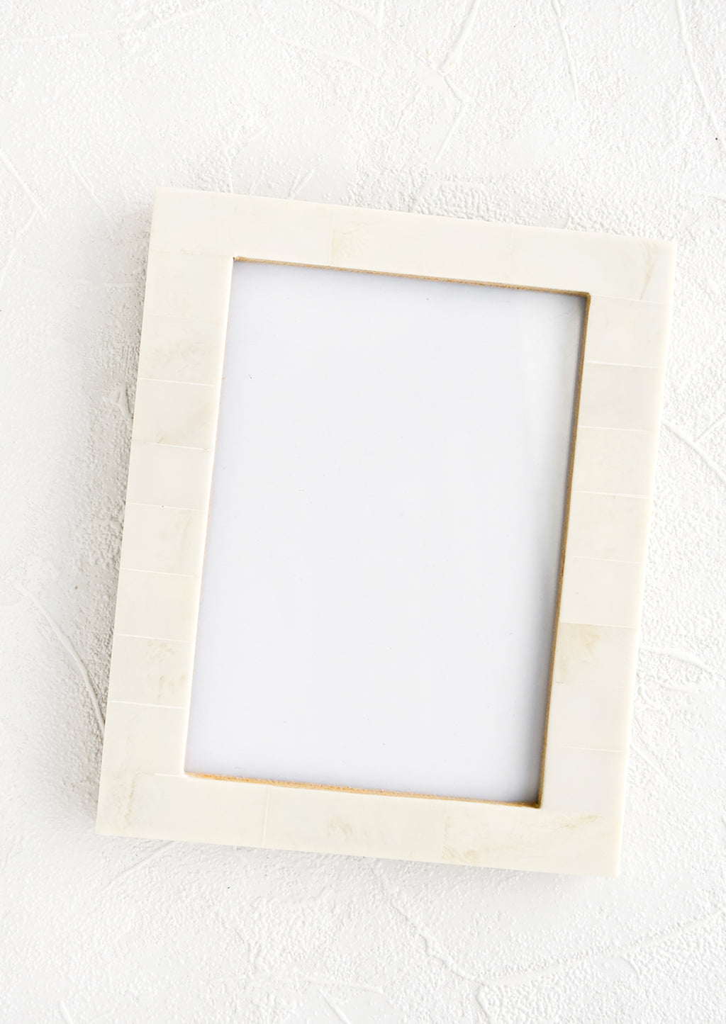 1: Picture frame designed for 5x7 photograph. Glass center with pale ivory border made from blocks of resin.