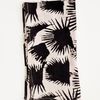 Tan: Block print cotton dinner napkin in beige with black palm leaf print