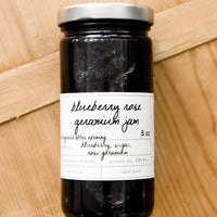 2: A glass jar of blueberry jam.