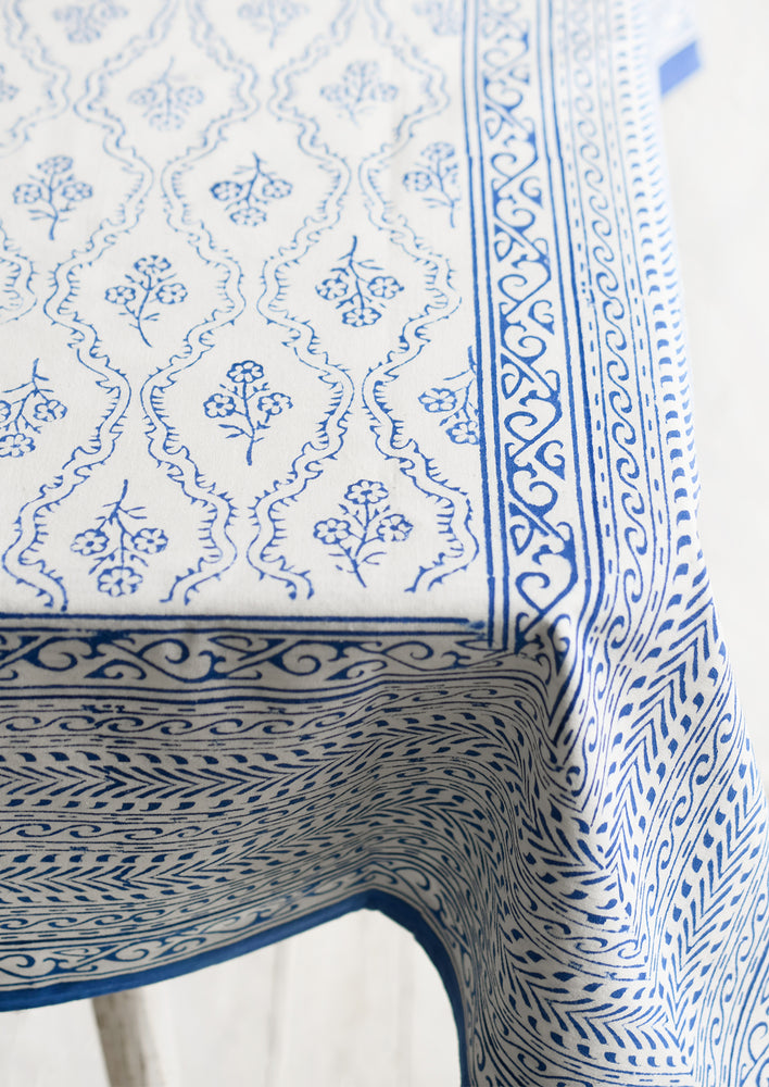 A blue and white block printed, floral print tablecloth.