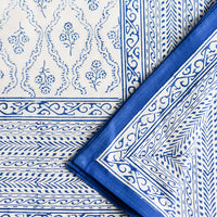 1: A blue and white block printed, floral print tablecloth.