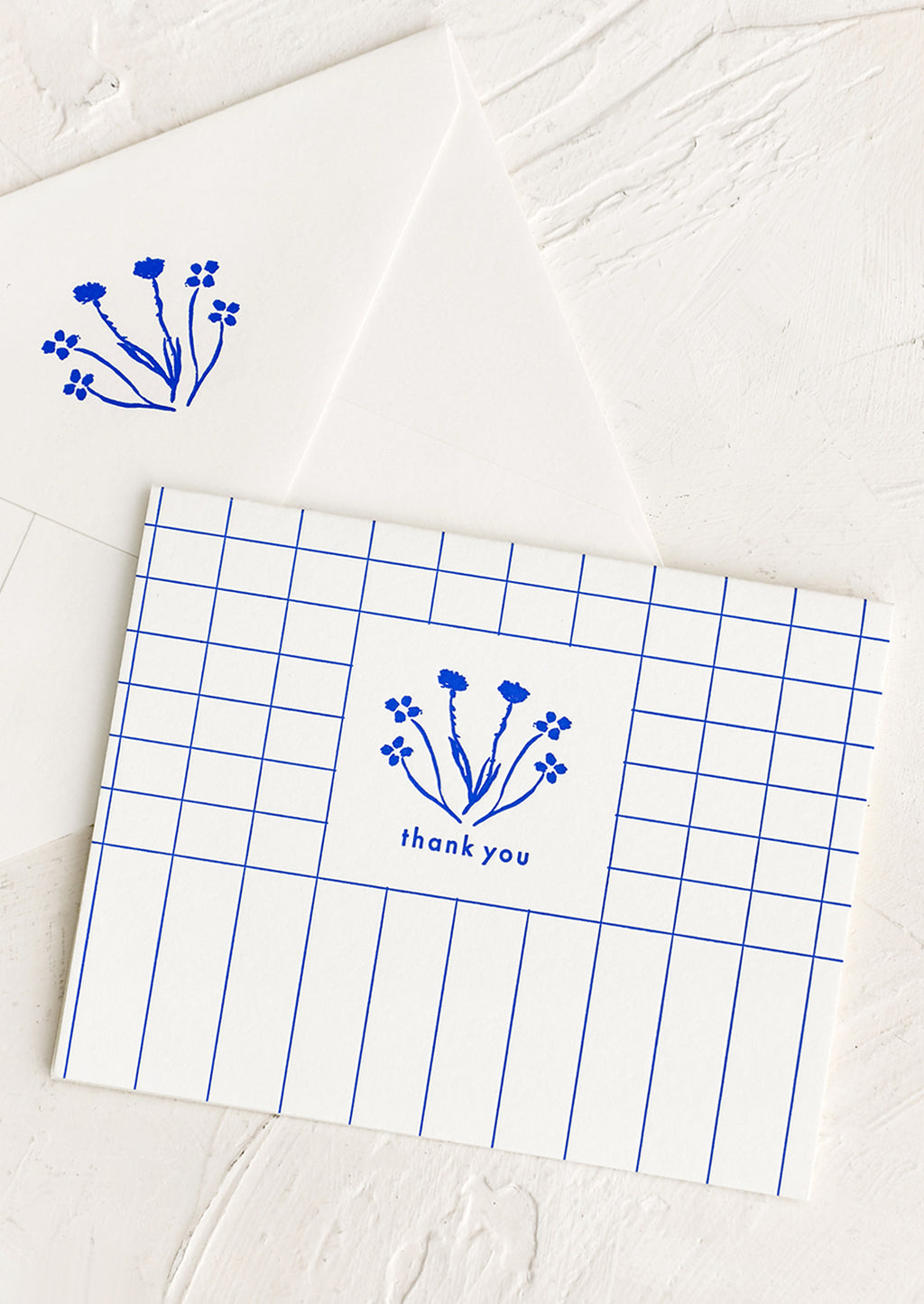 Single Card: A blue and white grid patterned thank you card with drawn floral imagery.