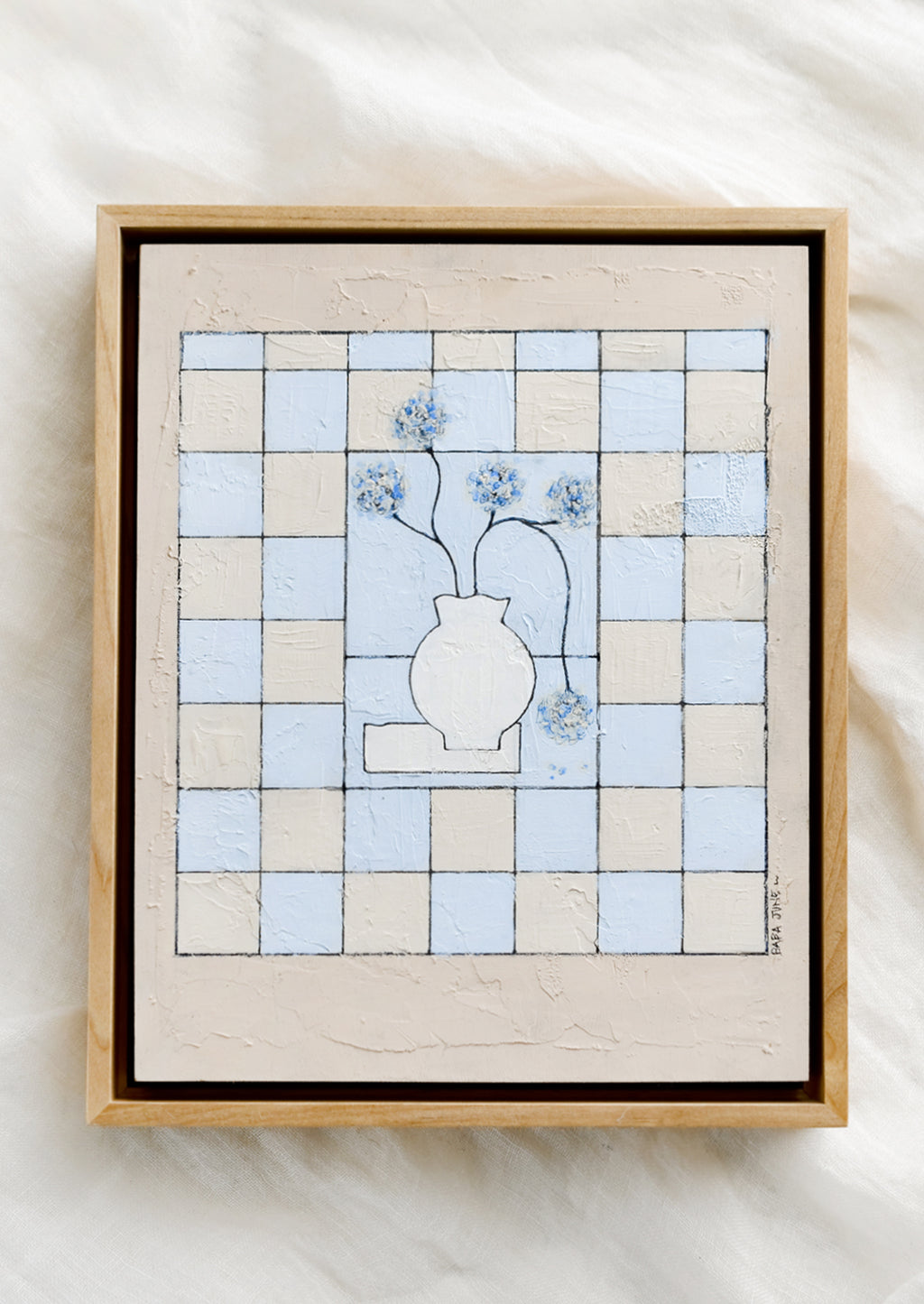 1: A framed original painting of still life vase with flowers on a checkered beige and periwinkle background.