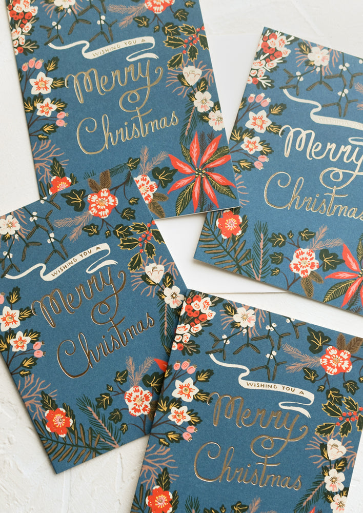2: Blue greeting cards with poinsettia floral print, gold text reads "Wishing you a merry christmas".
