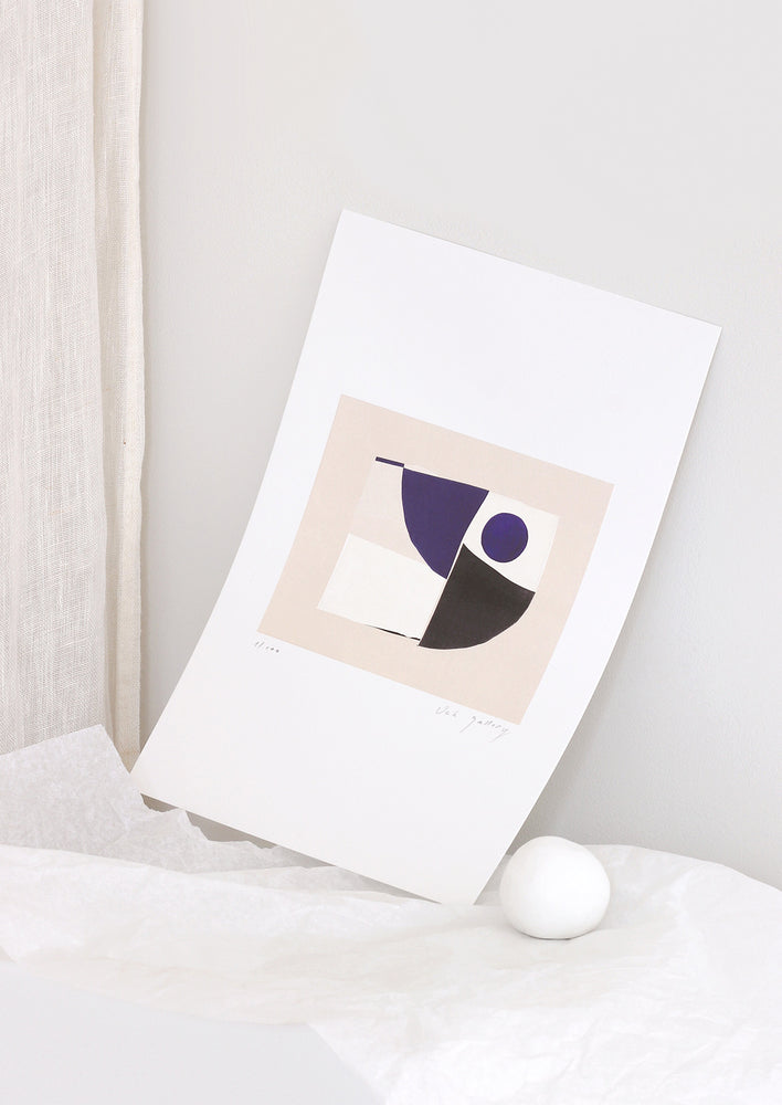 A geometric abstract art print in a minimally styled, decorative setting.