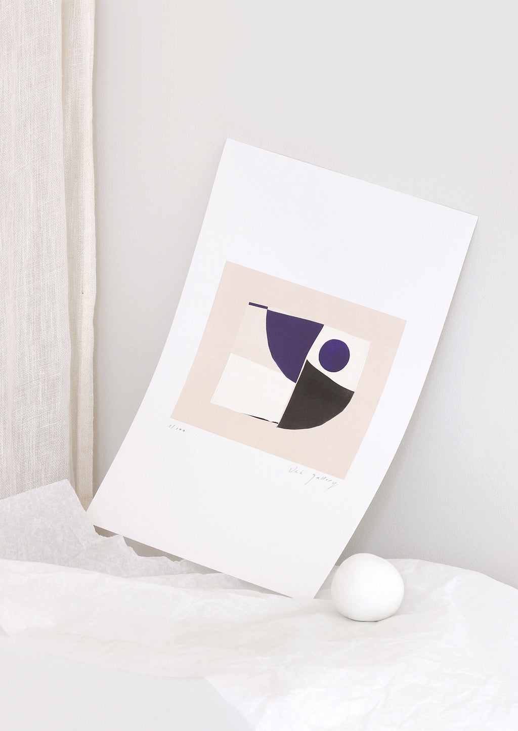 2: A geometric abstract art print in a minimally styled, decorative setting.