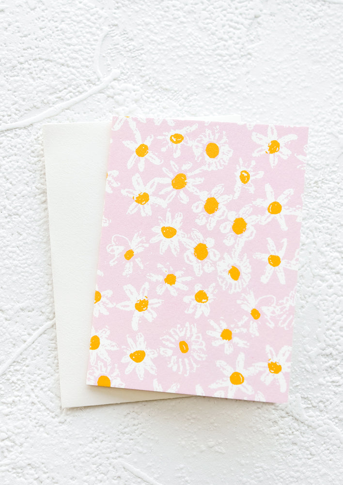 A gift enclosure greeting card with a pink background and daisy print.
