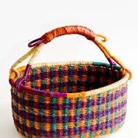 1: Woven basket made from multicolor dyed elephant grass with leather wrapped carrying handle