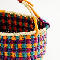 2: Woven basket made from multicolor dyed elephant grass with leather wrapped carrying handle